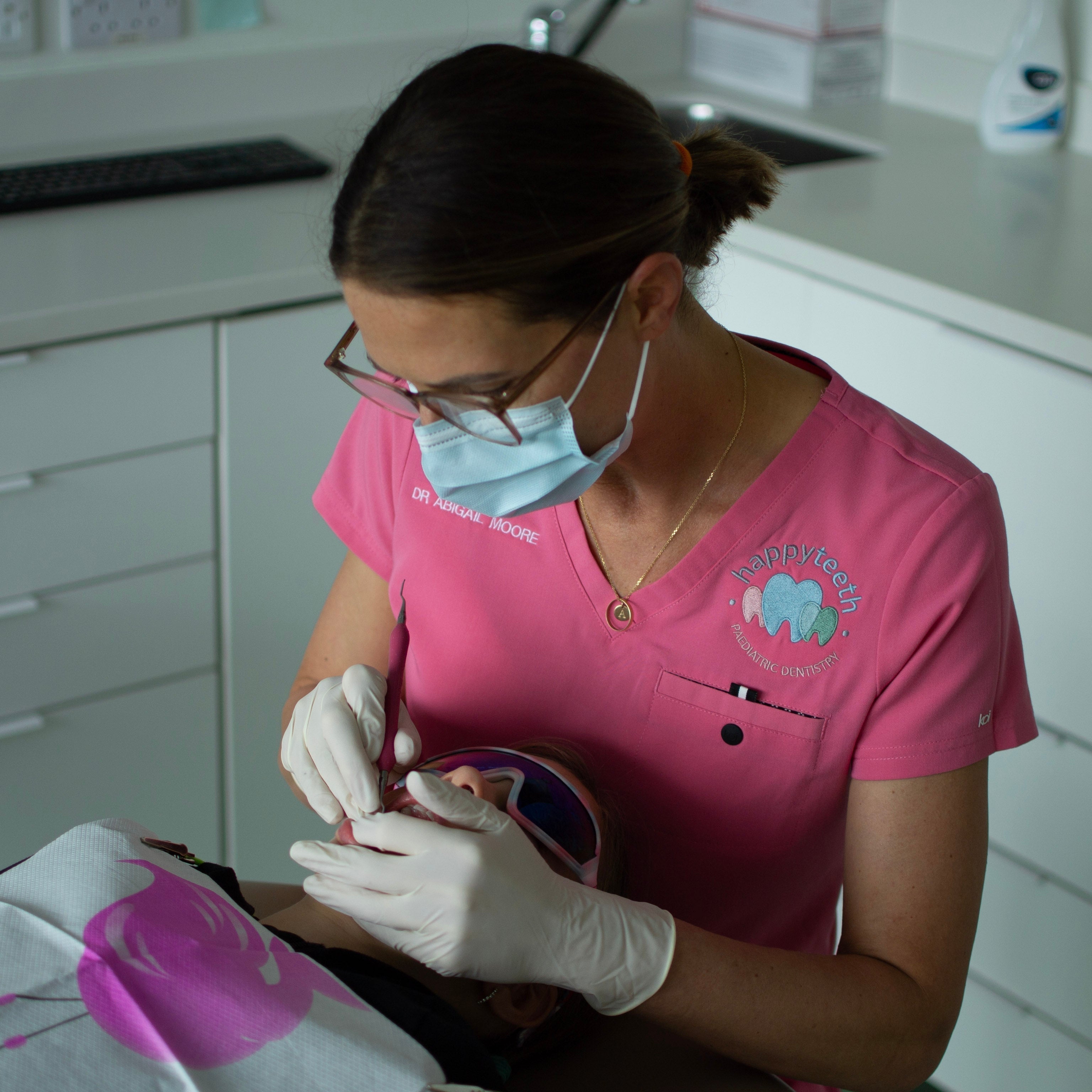 Dentiste en tenue médicale rose
