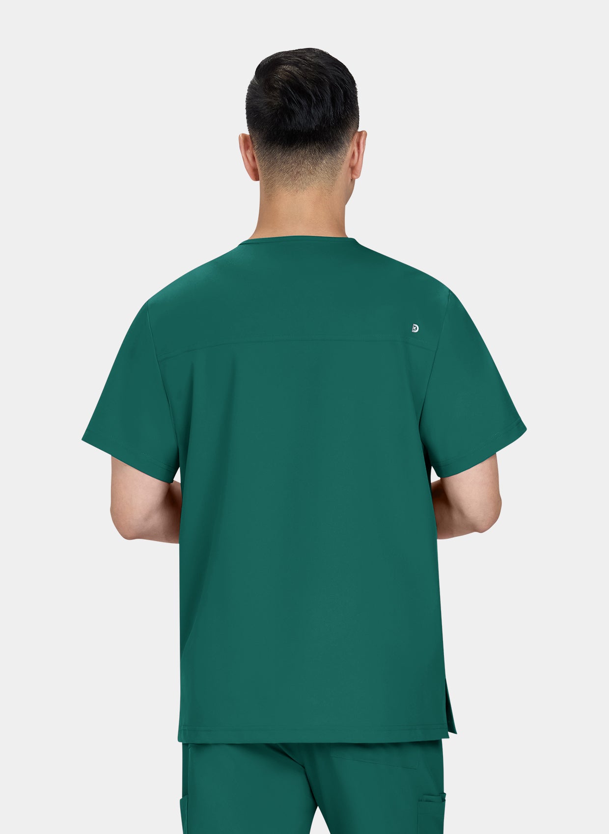 Homme de dos portant une blouse medicale koi cureology stasis vert foret 
